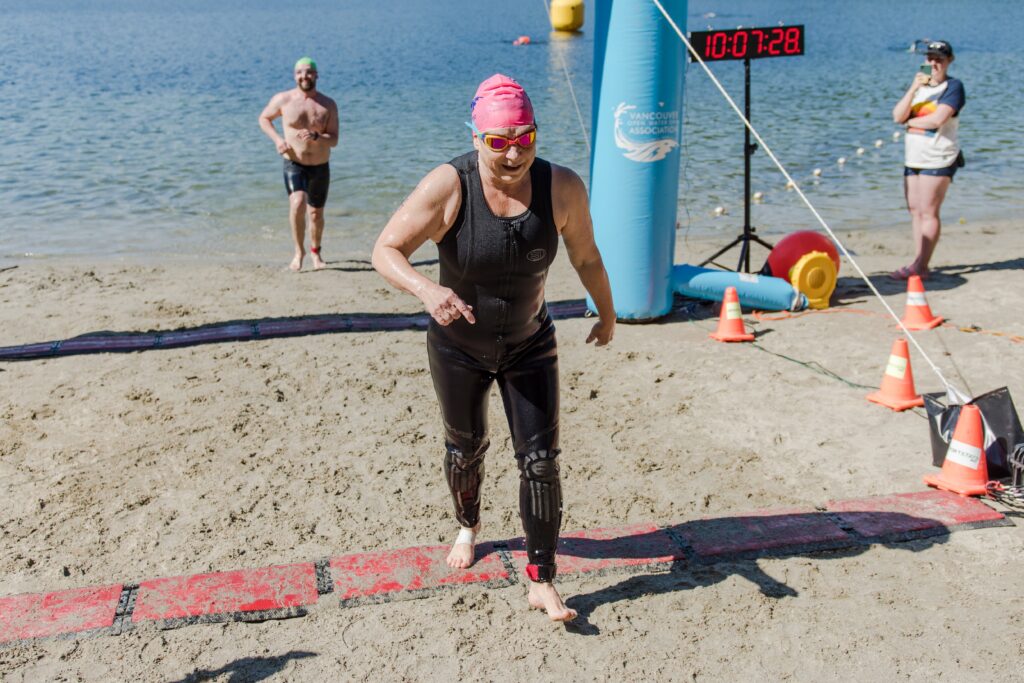 A swimmer crosses the finish line