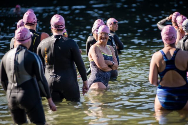 Women waiting for the race to start, with one smiling at the camera.